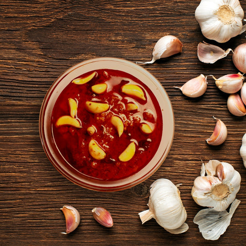 A bowl filled with homemade garlic pickle.