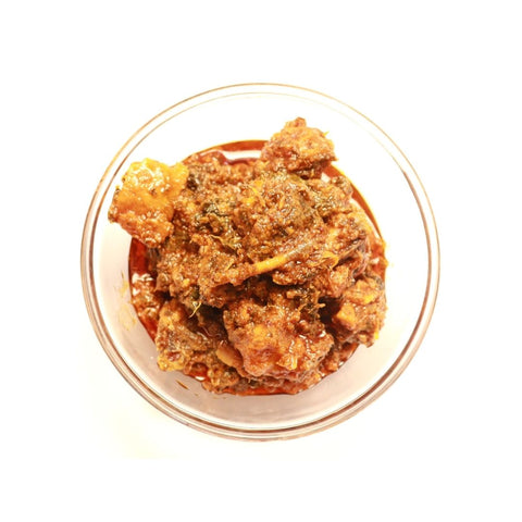 A bowl filled with vibrant red Gongura Chicken Pickle.