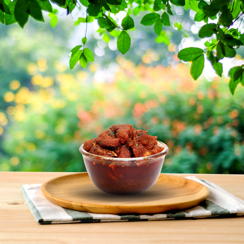 A bowl filled with spicy and flavorful chicken pickle