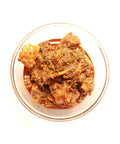 A bowl filled with vibrant red Gongura Chicken Pickle.
