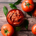 A bowl of vibrant red tomato pickle.